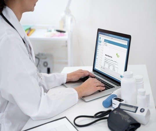Doctor typing on laptop